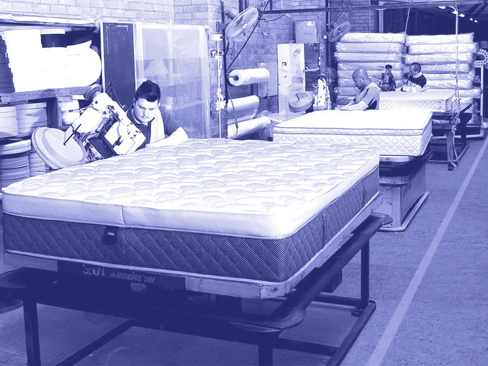 A machinist finishing a mattress on the production line