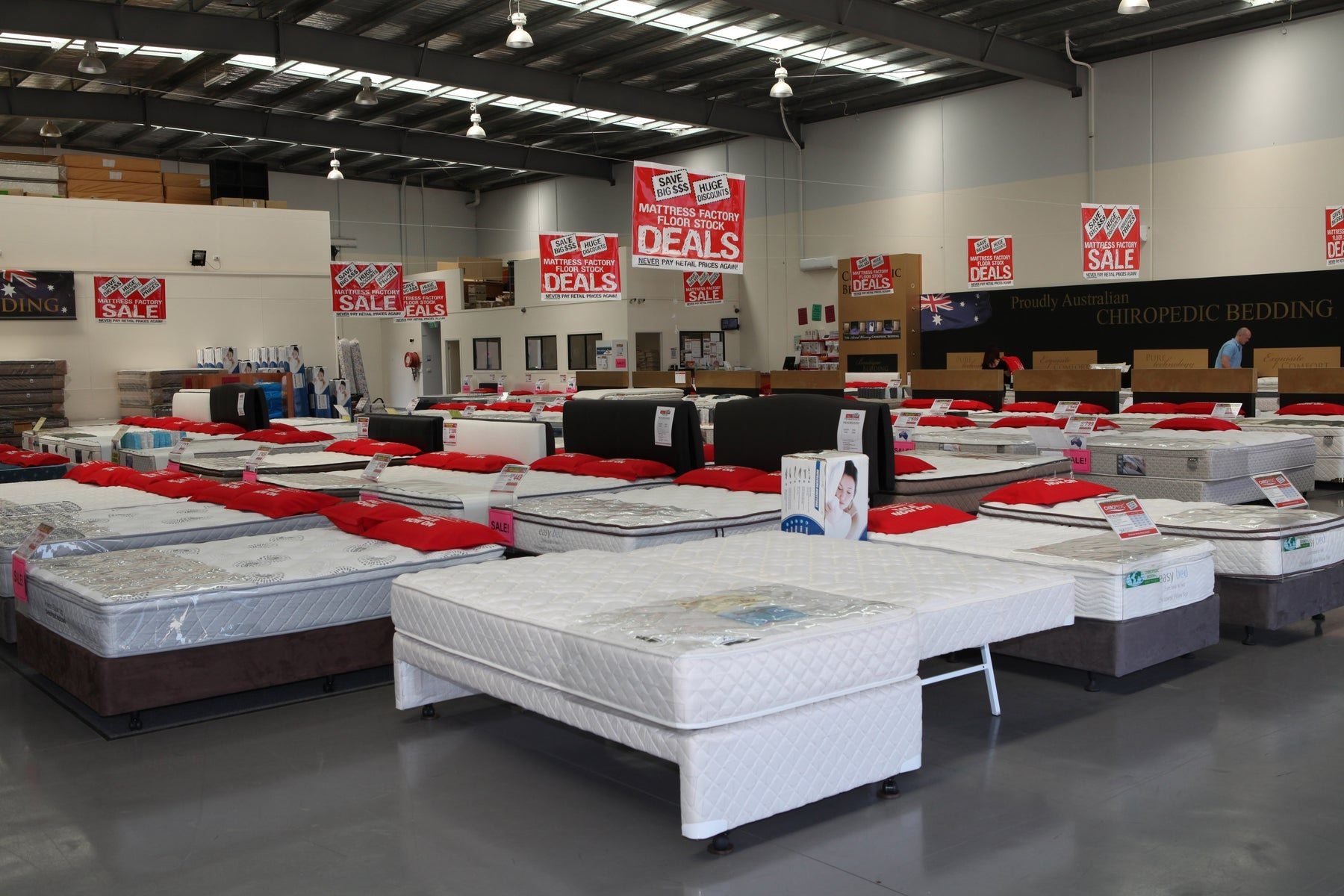 A mattress showroom floor with beds on display
