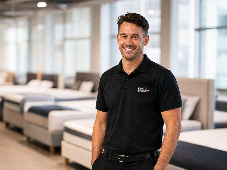 A smiling Sleep Collective team member in a branded polo